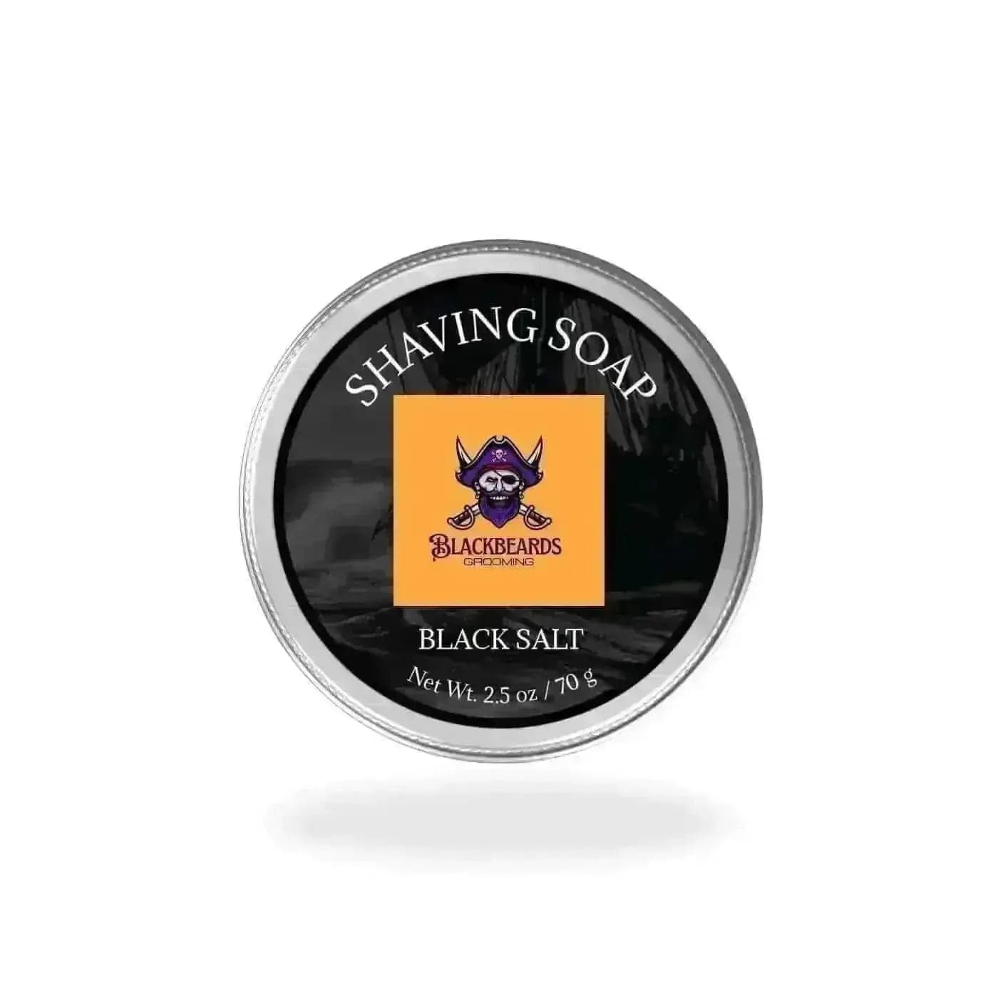 black salt shaving soap in a tin on a white background