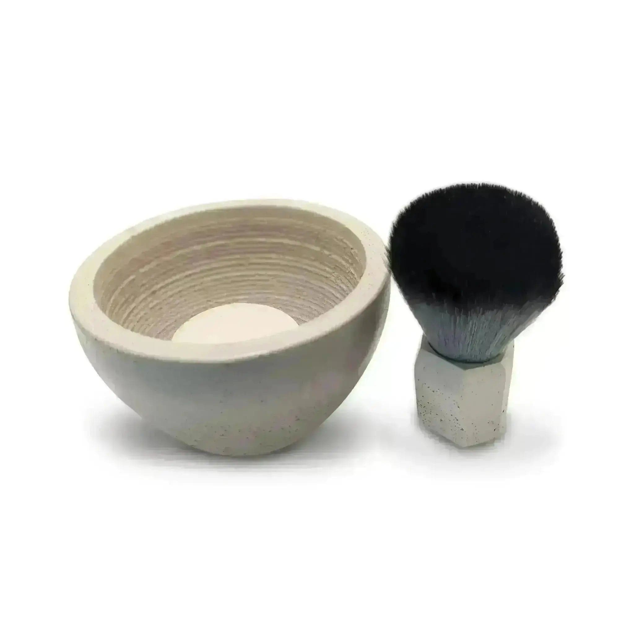a white bowl with a black brush in it