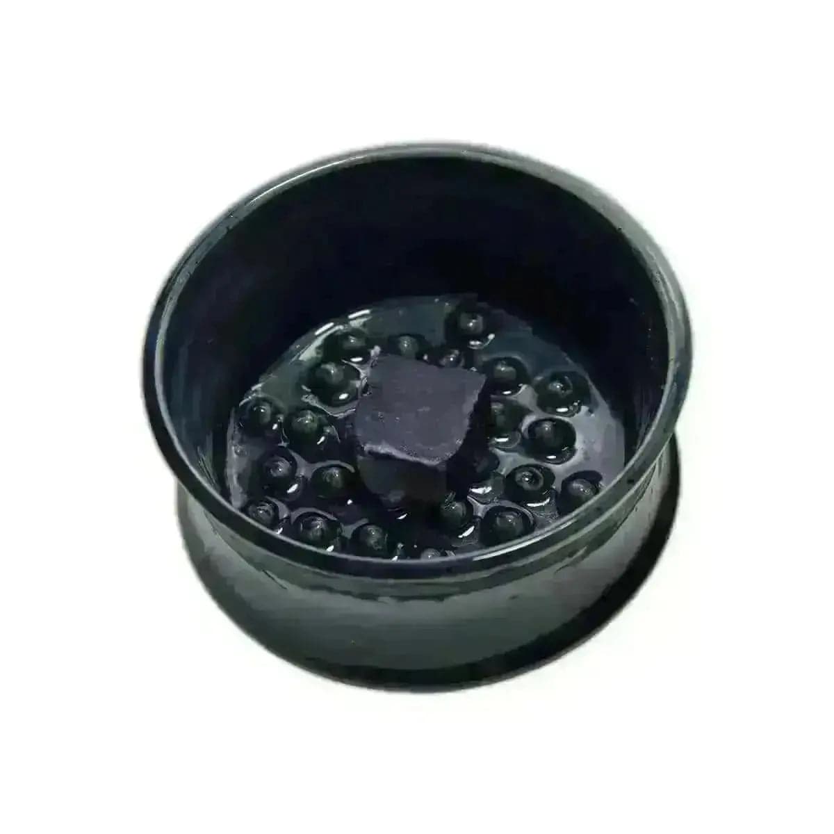 a black container filled with lots of black balls